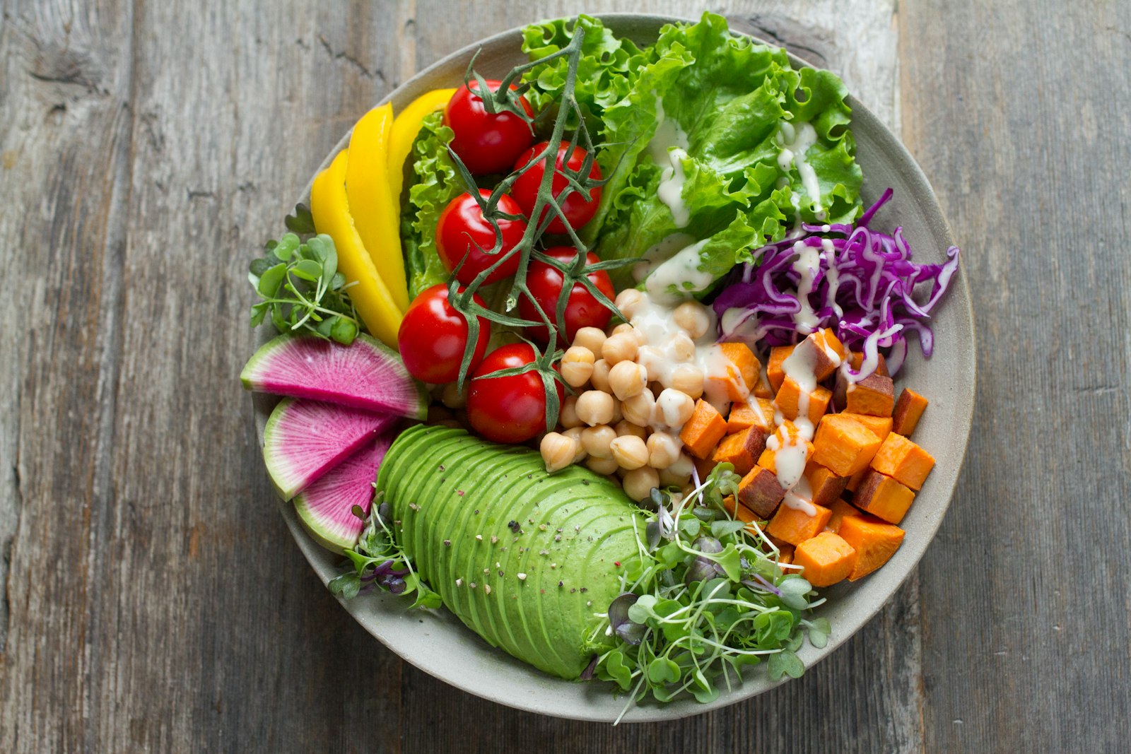 Fresh healthy vegan food bowl with avocado greens and colourful vegetables at a Dubai beach club