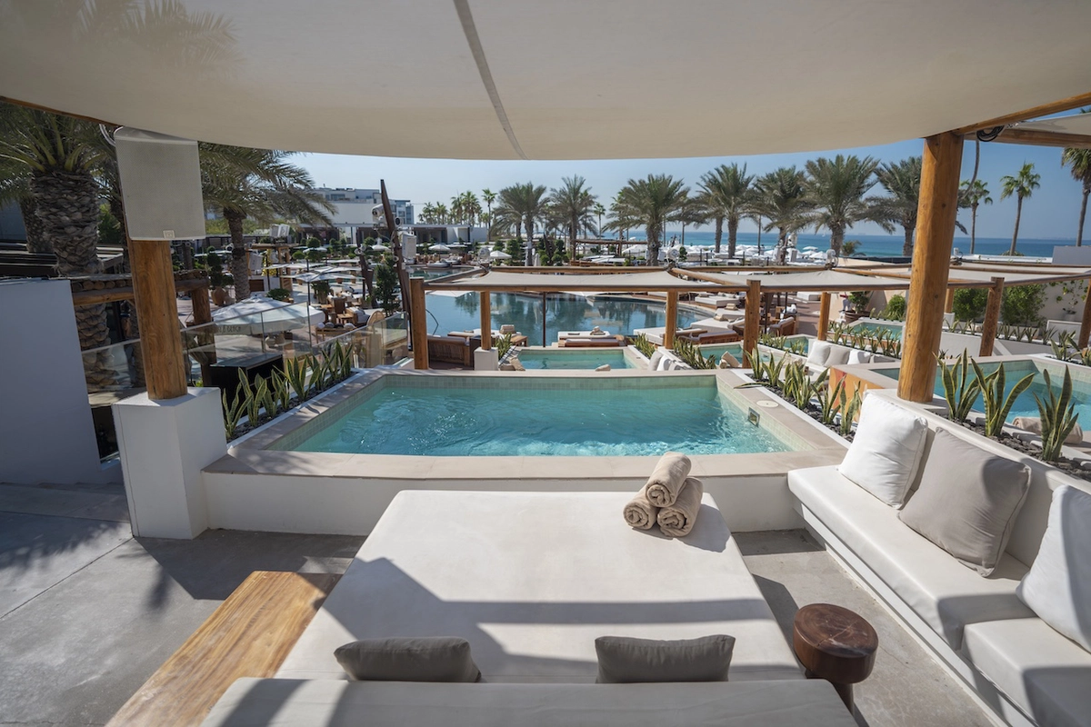 Nikki Beach Dubai white sunbeds by the pool